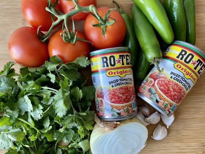 Photo of salsa roja ingredients, including Ro-Tel, tomatoes, peppers, cilantro, onion, and garlic.