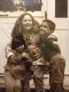 Photo of the author and her curly hair as a child next to her siblings.